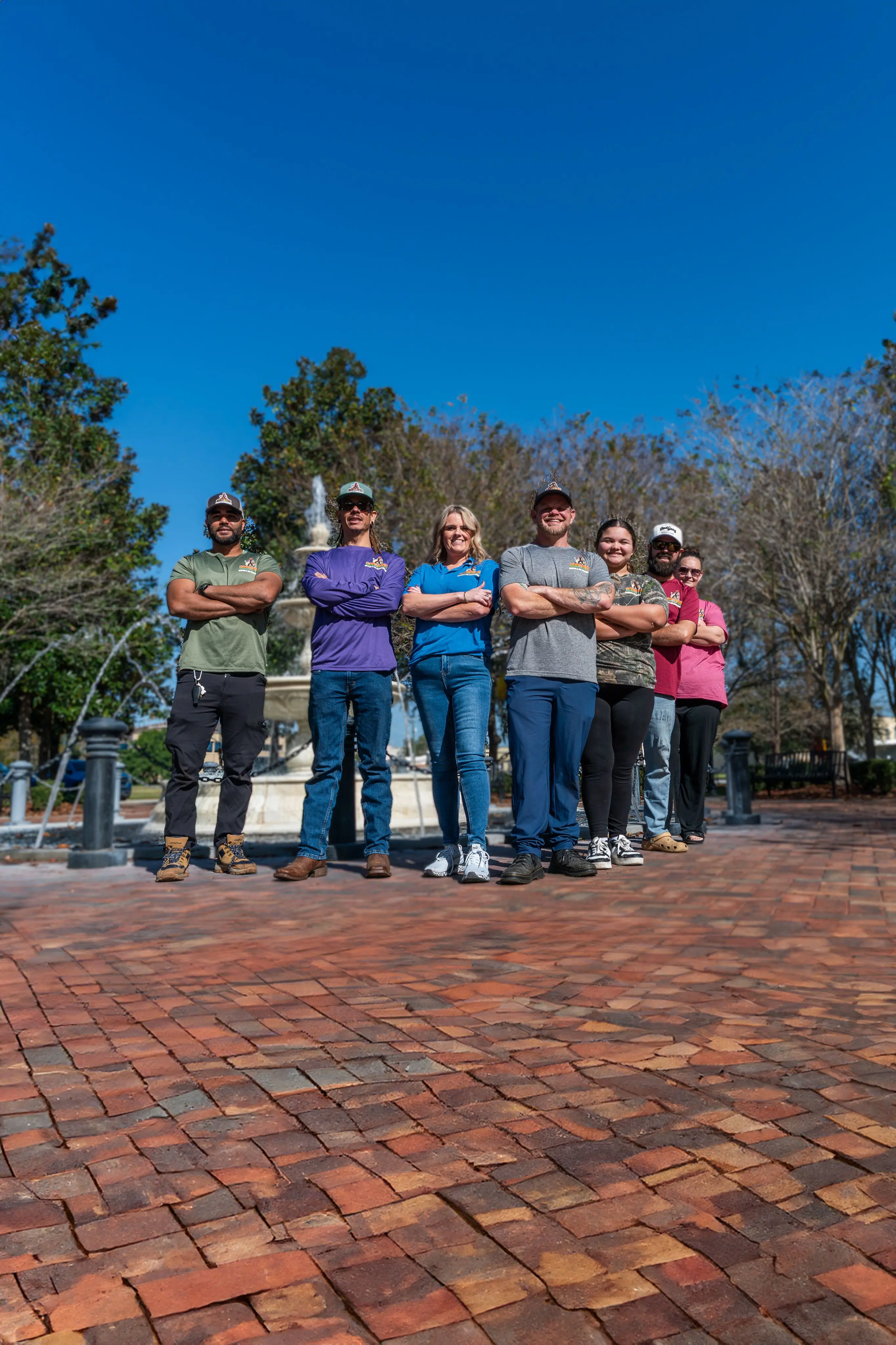 The employees standing next to each other and smiling