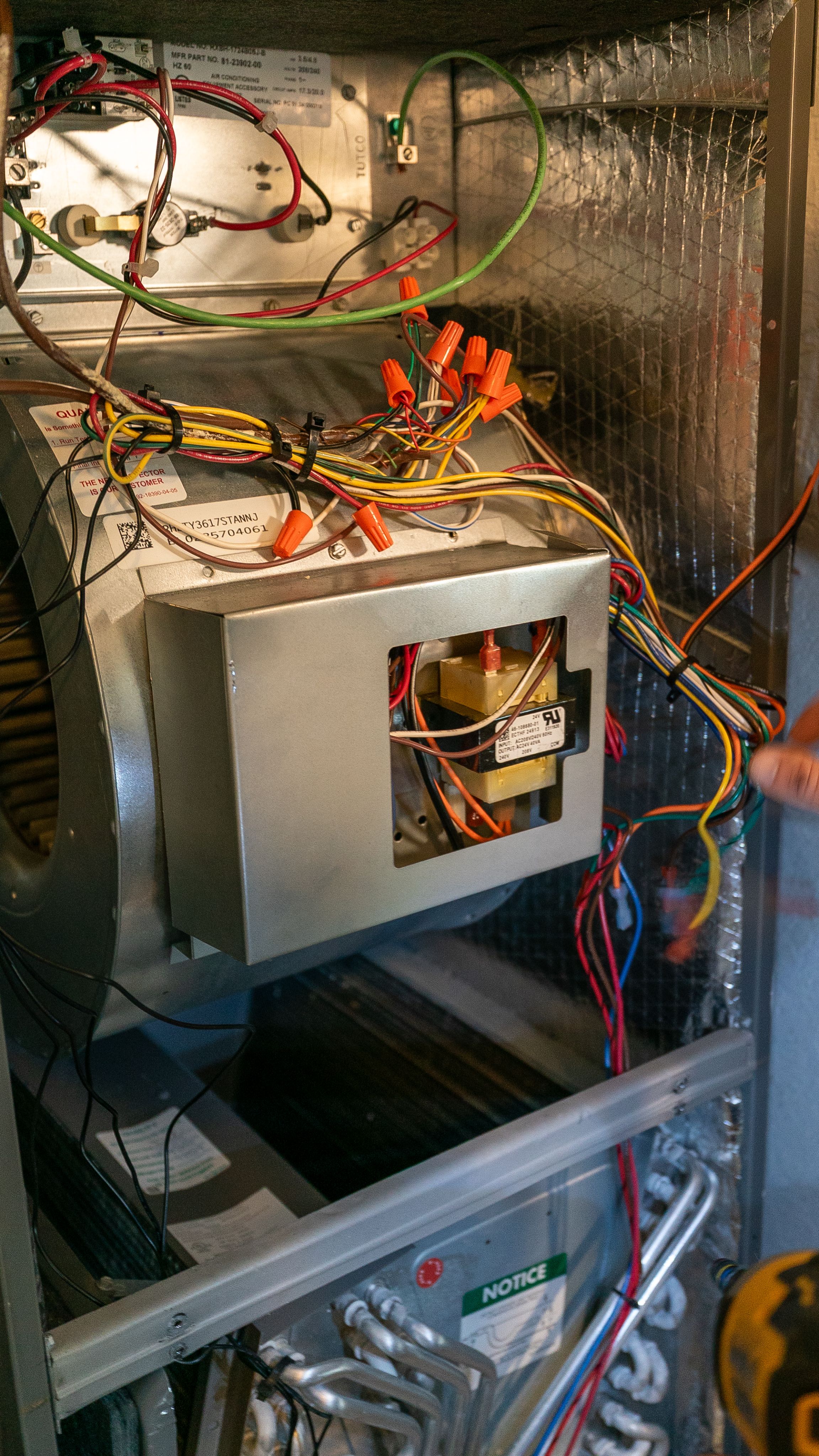 HVAC technician inspecting the inside of an air handler unit