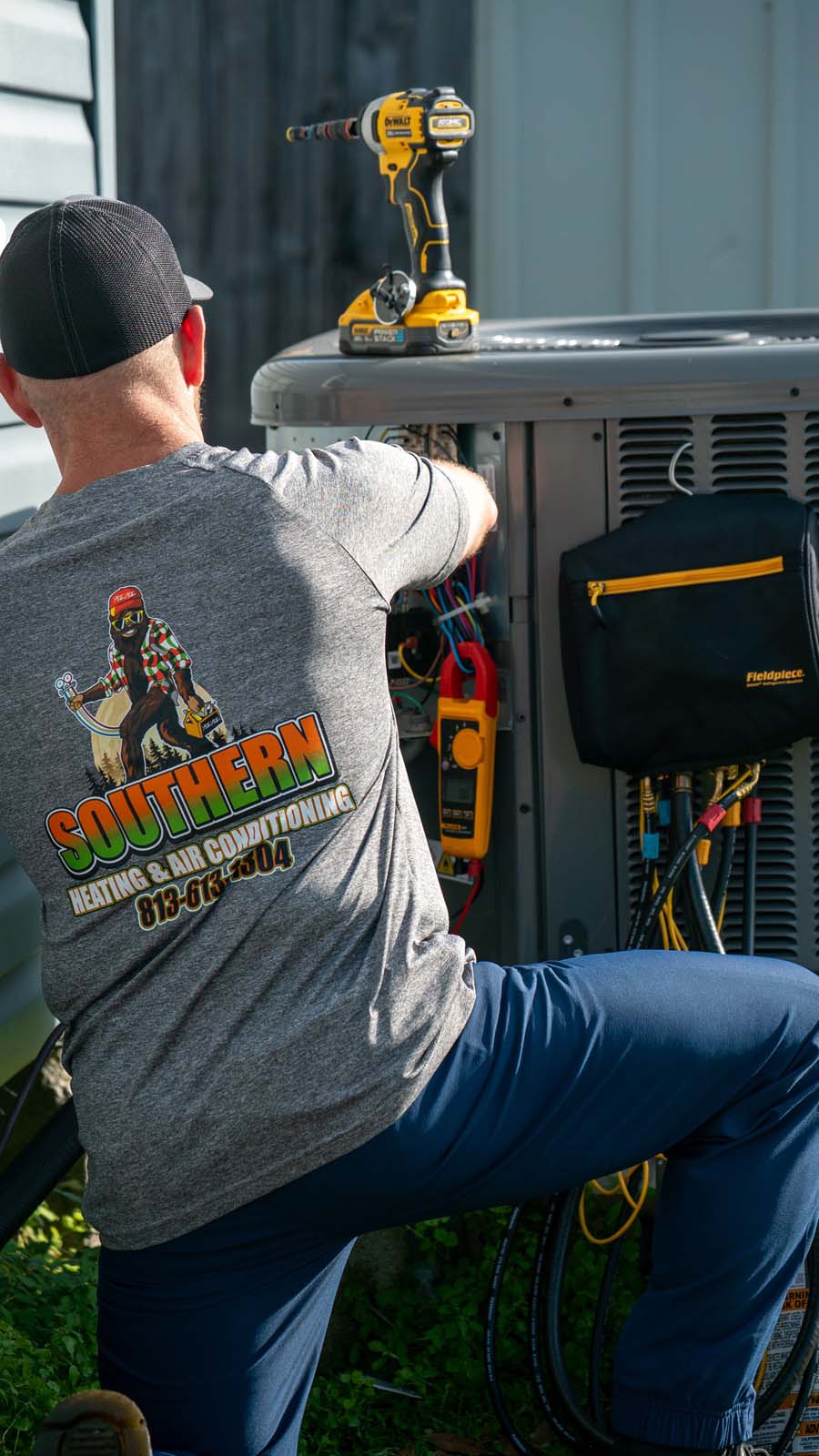 HVAC technician servicing an outdoor air conditioning unit in Brandon, Florida