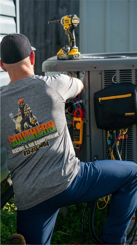 Technician performing HVAC maintenance outdoors