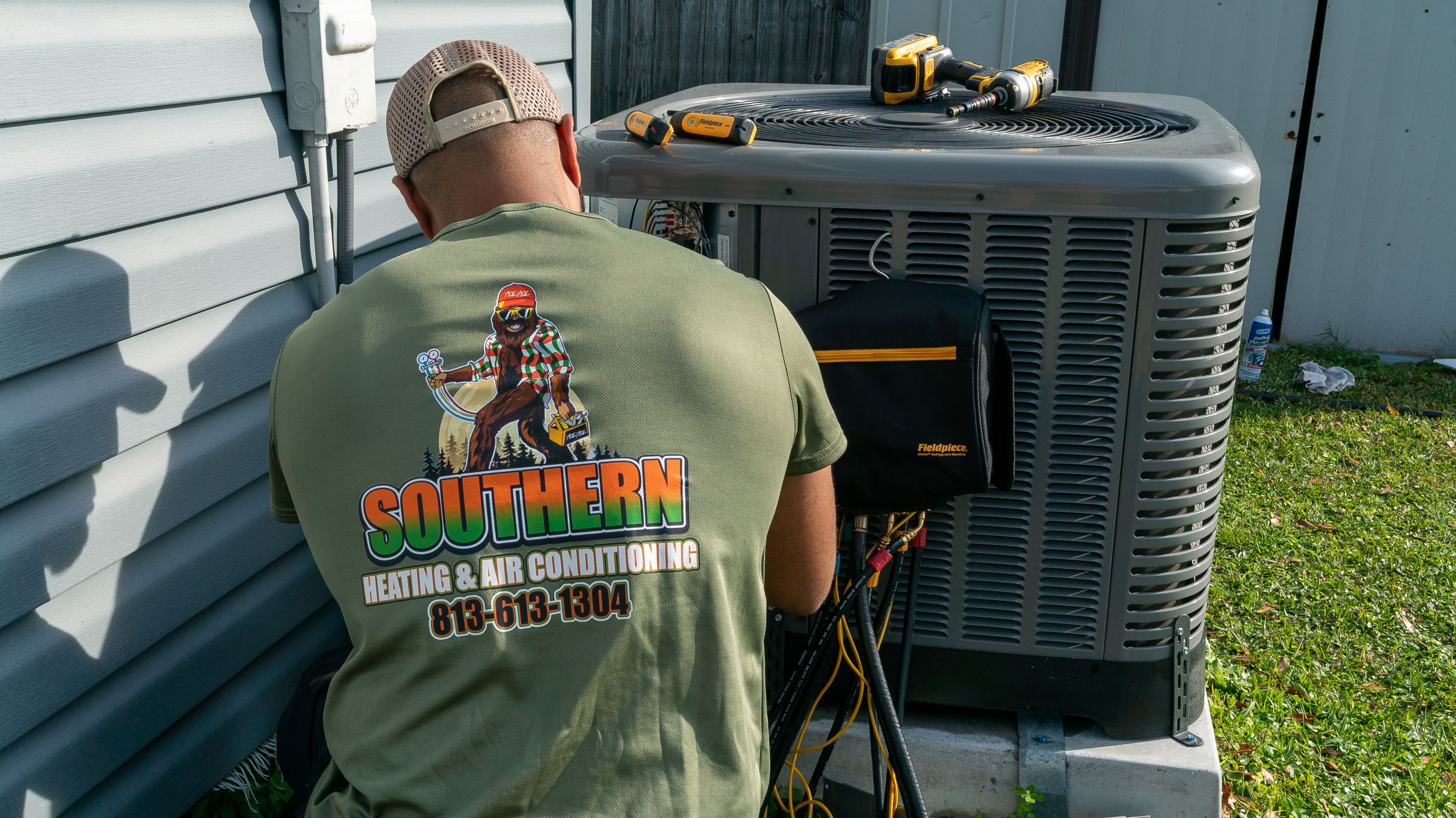 Technician repairing a residential air conditioning unit in Brandon, Florida