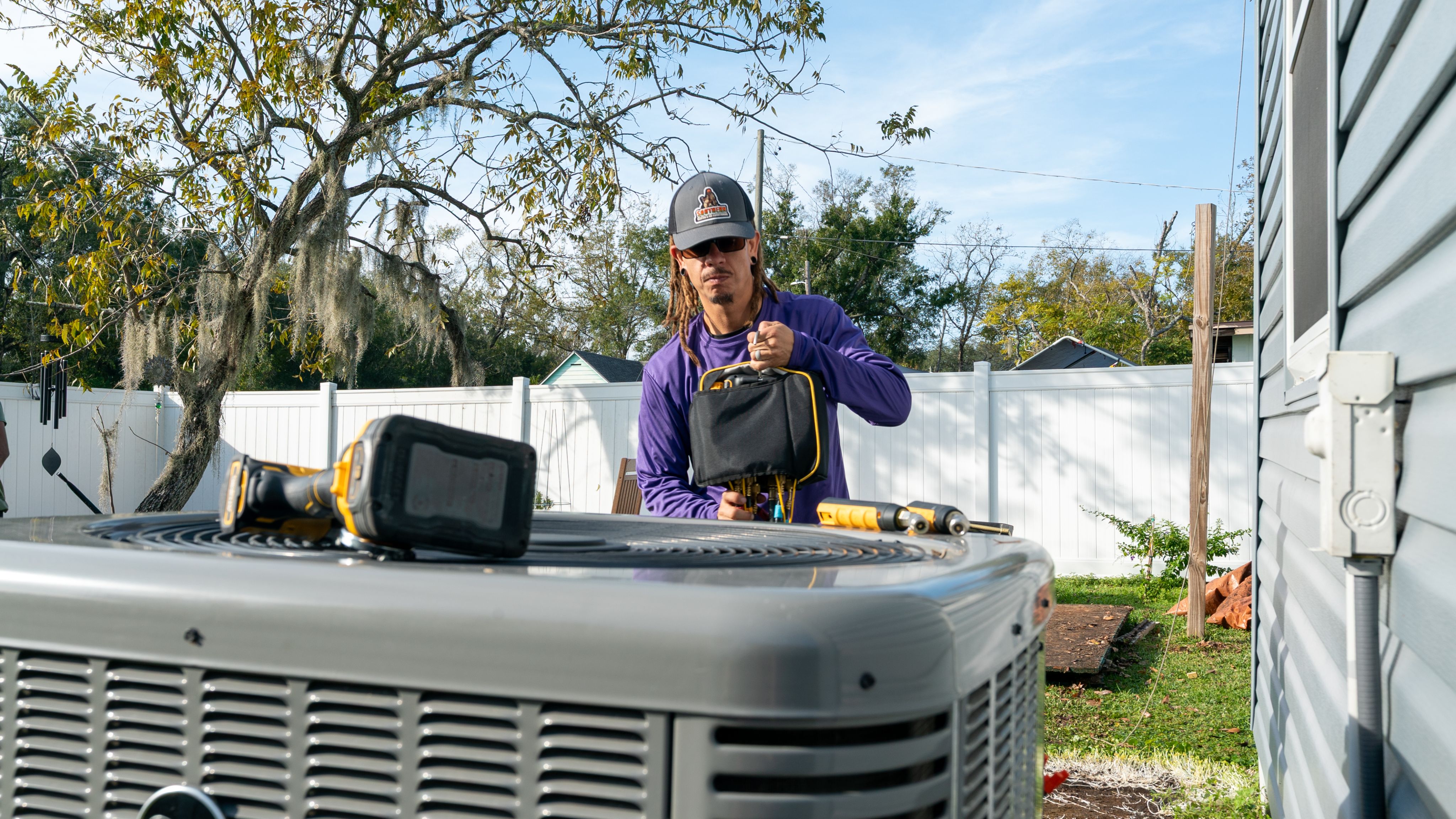 HVAC technician servicing an outdoor air conditioning unit in Dover, Florida