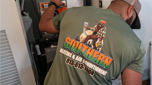 A man wearing a shirt with the Southern Heating and AC logo on the back