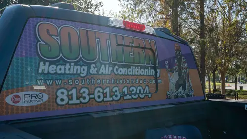 A pickup truck with the Southern Heating and AC logo on the back window